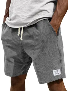 Close-up detail of gray corduroy shorts for men featuring drawstring waist and white leg label