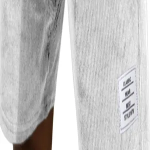 Close-up detail of the white classic wear label on textured corduroy casual men's shorts.