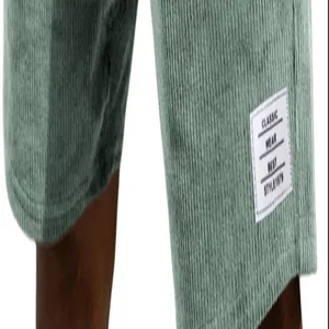 Close-up detail of white label and texture on green corduroy men's casual shorts