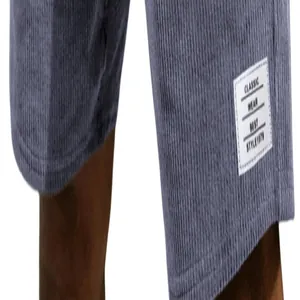 Detailed macro view of the white decorative label on these grey corduroy men's shorts