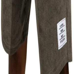 Detailed macro view of brown corduroy shorts featuring a classic white sewn label
