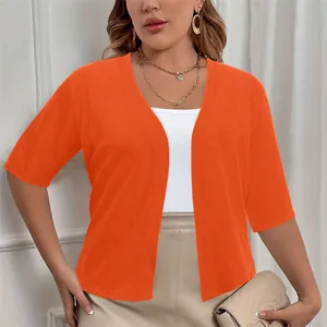 Detailed front view of an elegant plus size women's orange short sleeve knit shrug