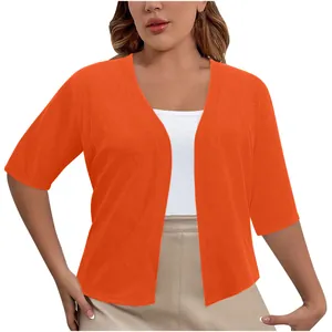 Front view detail of an elegant orange short-sleeve open-front shrug cardigan on a model