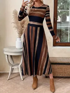 Full-length view of long-sleeved striped patchwork maxi dress with a flattering cinched waist