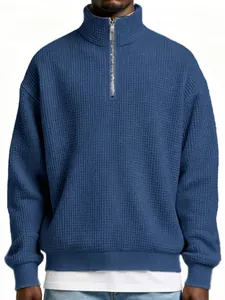Detailed shot of textured blue waffle-knit quarter-zip pullover for men's casual wear
