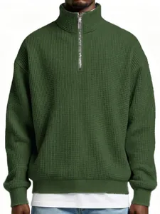 Close-up of men's loose olive green waffle knit half-zip pullover sweatshirt texture