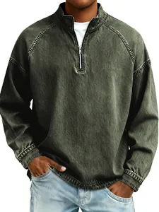 Detail shot of men's half-zip distressed washed denim sweatshirt in olive green.