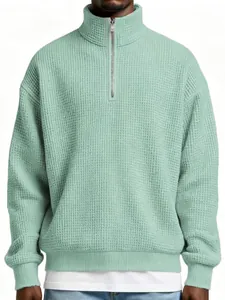 Close-up detail of a men's mint green waffle knit quarter-zip pullover sweatshirt