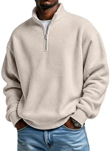 Close-up detail of men's beige waffle knit quarter-zip sweatshirt in a relaxed casual fit