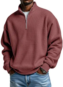 Detailed view of the texture on a men's burgundy quarter-zip waffle knit sweatshirt