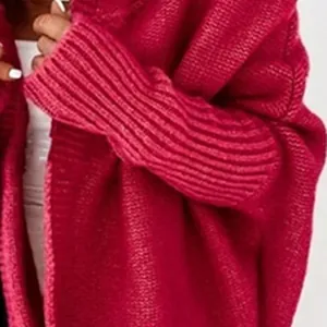Detailed macro view showing the chunky fuchsia knit texture of this batwing sleeve cardigan