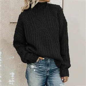 Detailed view of women's black high-neck cable-knit sweater with thick texture