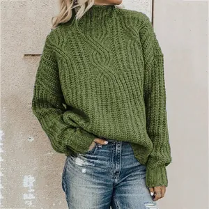 Close-up of olive green cable knit turtleneck sweater showing thick yarn texture detail