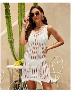 Macro view of detailed white crochet knit pattern on sleeveless beach cover-up dress