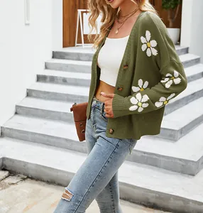 Dettaglio del cardigan oversize verde oliva con motivi floreali a margherita lavorati