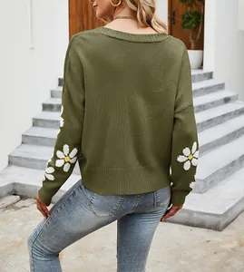 Vista posteriore di cardigan oversize verde oliva con ricami a margherita sulle maniche.