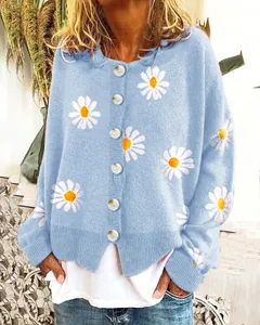 Detailaufnahme eines hellblauen Cardigans mit weißen Gänseblümchen-Stickereien