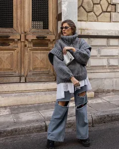 Chunky grey turtleneck knit sweater styled with ripped jeans for a chic street look