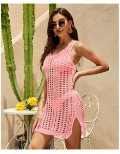 Close-up detail of pink hollow-out crochet knit dress featuring stylish side slit texture