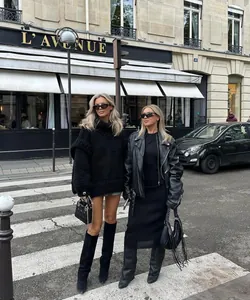 Close-up of oversized black chunky knit turtleneck sweater in European street setting
