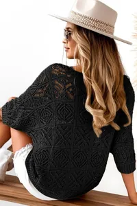Detail view of black crochet hollow-out knit sweater with stylish three-quarter sleeves.