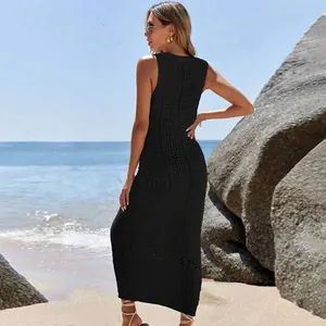 Close-up view of a black sleeveless crochet knit maxi dress used as a beach cover-up