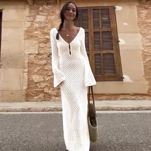 Weiße Strick-Strandkleid-Detailansicht am Model vor rustikaler Kulisse im Freien