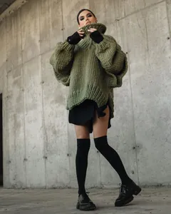 Detailed view of a women's oversized chunky knit high-neck sweater in stylish olive green