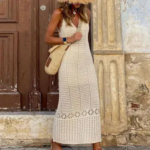 Close-up view of beige knitted crochet maxi dress with hollow out patterns for beach