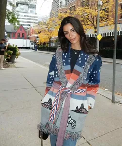 Detailed view of heavy jacquard wool cardigan with fringe and urban pattern