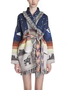 Detailed view of heavy jacquard wool knit cardigan with fringe and wolf landscape pattern.
