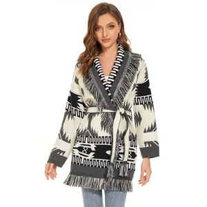 Detail of ethnic geometric pattern knit cardigan with fringe hem and tie-waist belt.