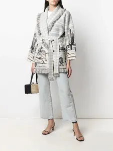 Detail of long cactus jacquard cardigan with fringe trim and belt closure