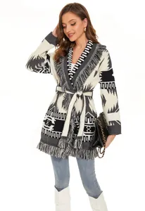 Detailed view of a thick ethnic style cardigan with geometric patterns and fringe.