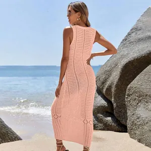 Elegant pink crochet knit sleeveless maxi beach cover-up dress shown on a beach model