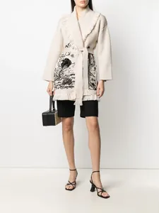 Detailed view of the beige cactus jacquard knit cardigan with elegant fringe trim