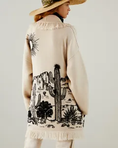 Back view of a long beige knit cardigan with detailed cactus jacquard and fringe hem