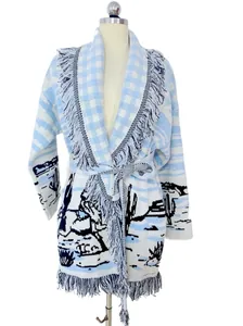 Detailed macro view of a light blue and white cactus jacquard cardigan with fringe trim