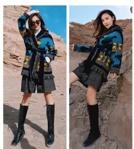 Stylish bohemian wool jacquard cardigan with ethnic patterns and fringe hem in desert setting.