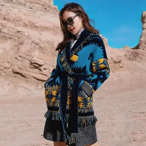 Detailed view of bohemian jacquard wool cardigan featuring fringe trim and waist belt