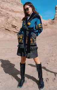 Elegant long bohemian jacquard wool cardigan with fringe detail and waist belt in desert