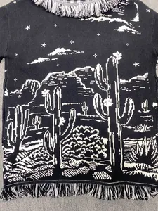 Close-up of black and white cactus jacquard knit cardigan with fringe details