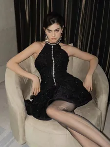 Elegant detailed view of luxury black halter neck dress with sparkling rhinestone accents