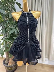 Detail view of black halter rhinestone evening dress with elegant ruching