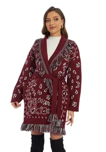Detail view of burgundy knitted cardigan with tassel fringe and white jacquard pattern