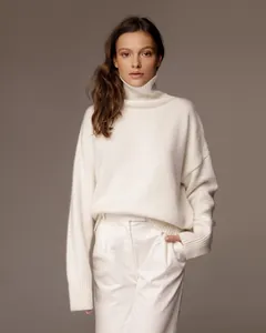 Detailed view of loose white high-neck knit sweater perfect for autumn and winter