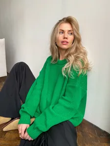 Detailed view of vibrant green knitted crewneck sweater with a loose oversized fit
