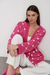 Stylish pink knit cardigan featuring white heart jacquard patterns for women's autumn fashion