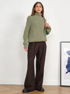 Detail view of stylish olive green chunky knit turtleneck sweater, cozy winter fashion