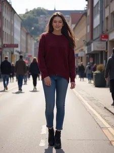 Femme élégante portant un pull en maille bordeaux ample marchant dans une rue européenne